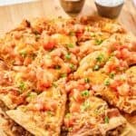 Copycat Taco Bell Mexican pizza and cups of taco sauce and sour cream.