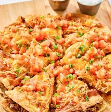 Copycat Taco Bell Mexican pizza and cups of taco sauce and sour cream.