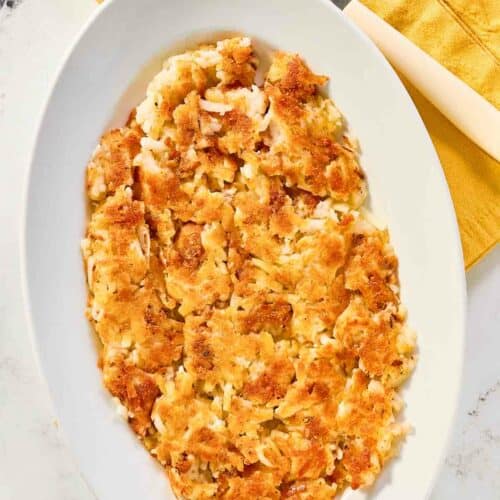 Copycat Waffle House hash browns on a plate and a fork next to it.