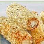Air fried corn cobs piled on a plate.