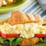 Homemade chicken salad chick egg salad in a croissant sandwich.