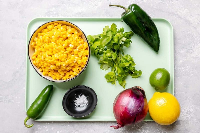 Copycat Chipotle corn salsa ingredients on a tray.