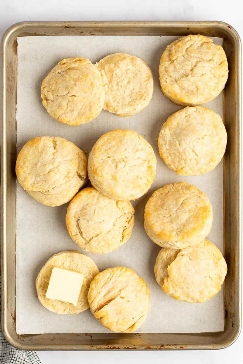 Homemade freezer biscuits on a baking sheet.