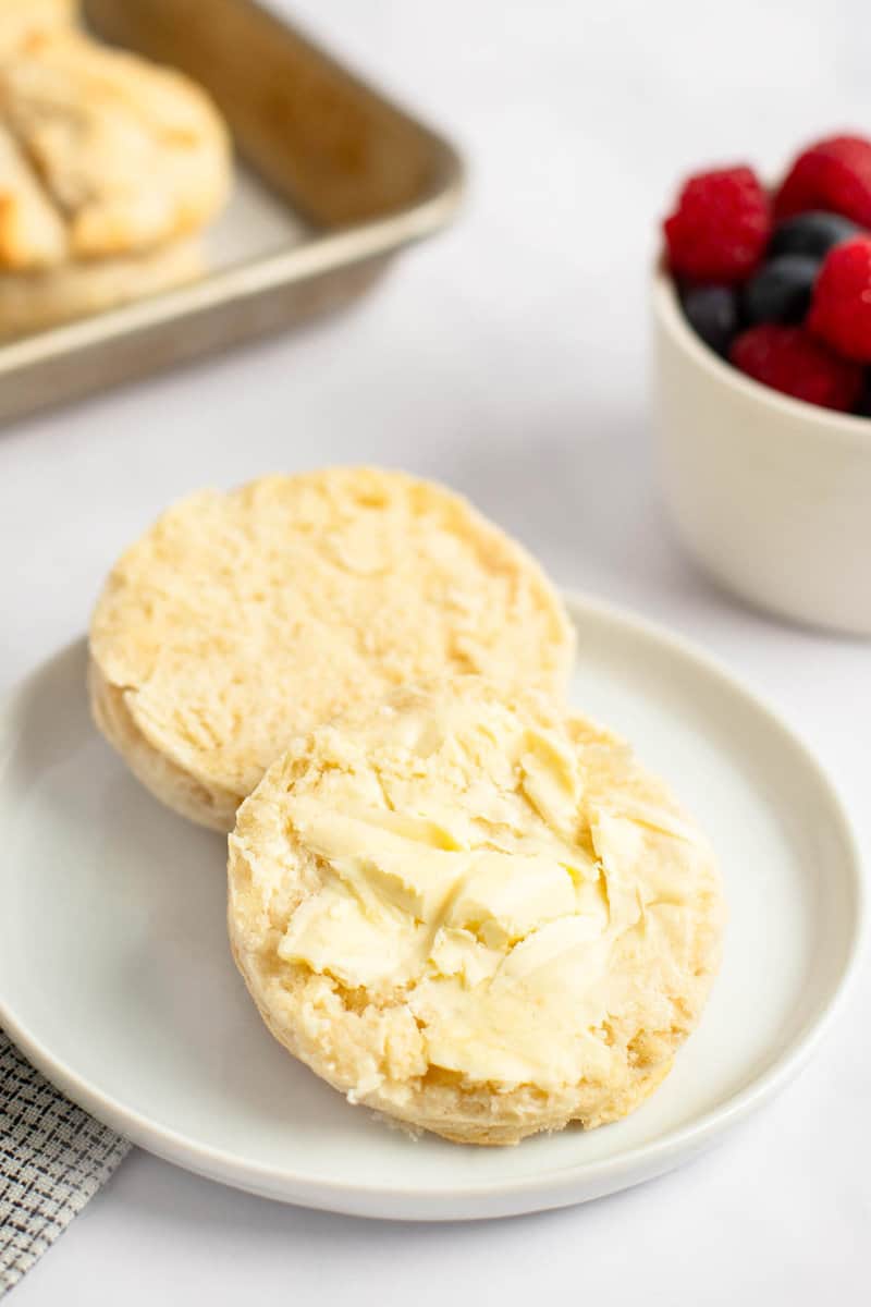 Homemade freezer biscuit with butter on a plate.
