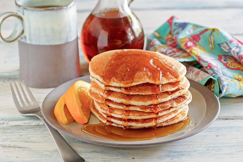 A stack of copycat IHOP country griddle cakes with syrup.