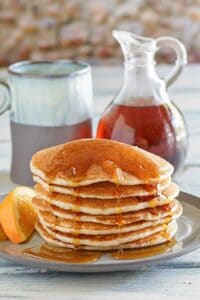 Copycat IHOP country griddle cakes topped with syrup on a plate.