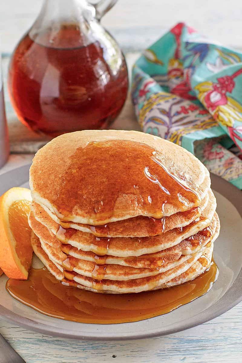 Copycat IHOP country griddle cakes with syrup on a plate.