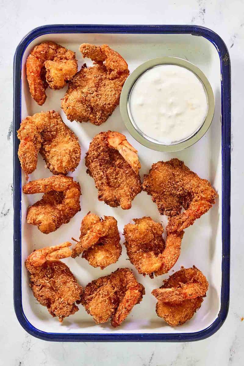 Copycat Red Lobster coconut shrimp and dipping sauce on a small serving tray.