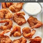 Homemade Red Lobster coconut shrimp and a small cup of dipping sauce.