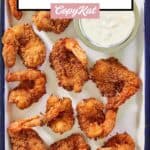 Homemade Red Lobster coconut shrimp and pina colada dipping sauce on a tray.