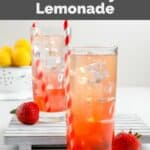 Two glasses of copycat Sonic strawberry lemonade, strawberries, and lemons.