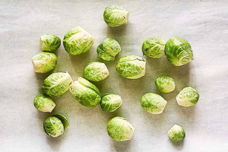 Trimmed Brussels sprouts on parchment paper.
