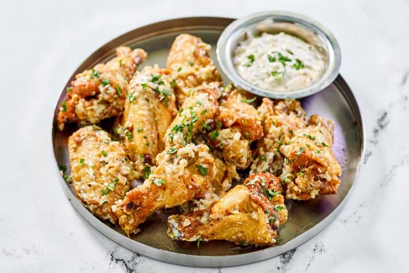 Copycat Buffalo Wild Wings garlic parmesan chicken wings and sauce.