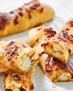 Several copycat Costco chicken bakes on parchment paper.