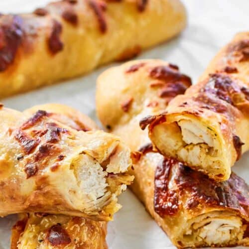 Several copycat Costco chicken bakes on parchment paper.