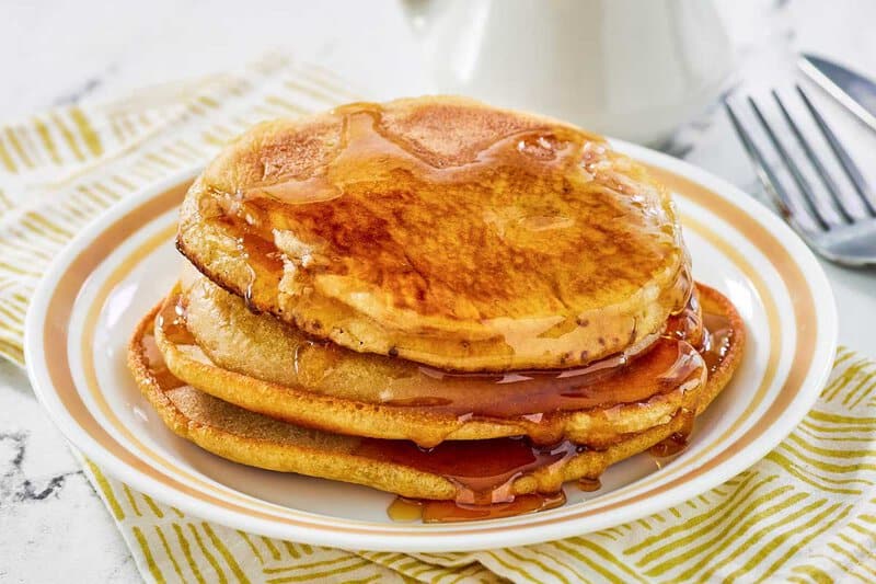 Copycat McDonald's pancakes and syrup on a plate.