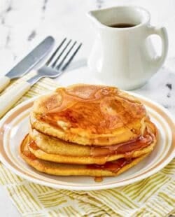 Copycat McDonald's pancakes with buttery maple syrup on a plate.