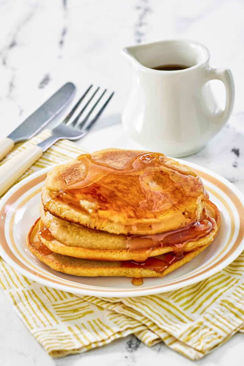 Copycat McDonald's pancakes with buttery maple syrup on a plate.