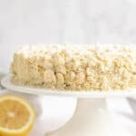Copycat Olive Garden lemon cream cake on a cake stand.