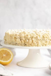 Copycat Olive Garden lemon cream cake on a cake stand.