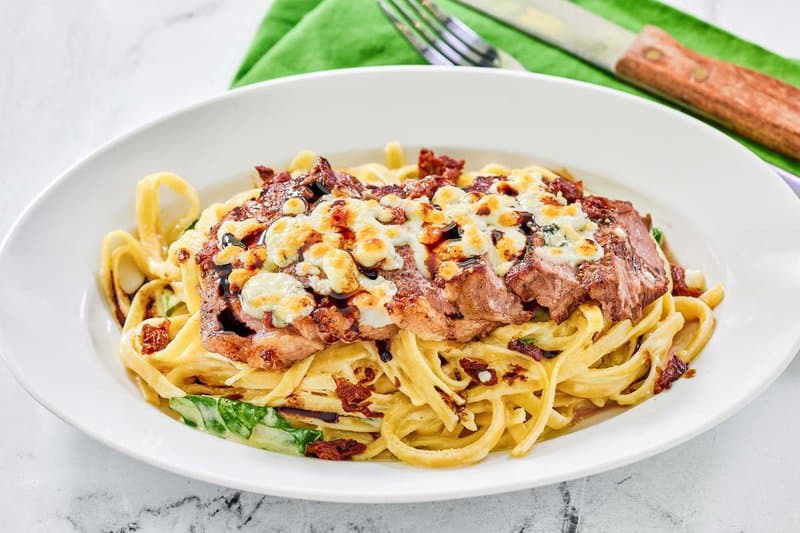Copycat Olive Garden steak gorgonzola pasta on a platter.