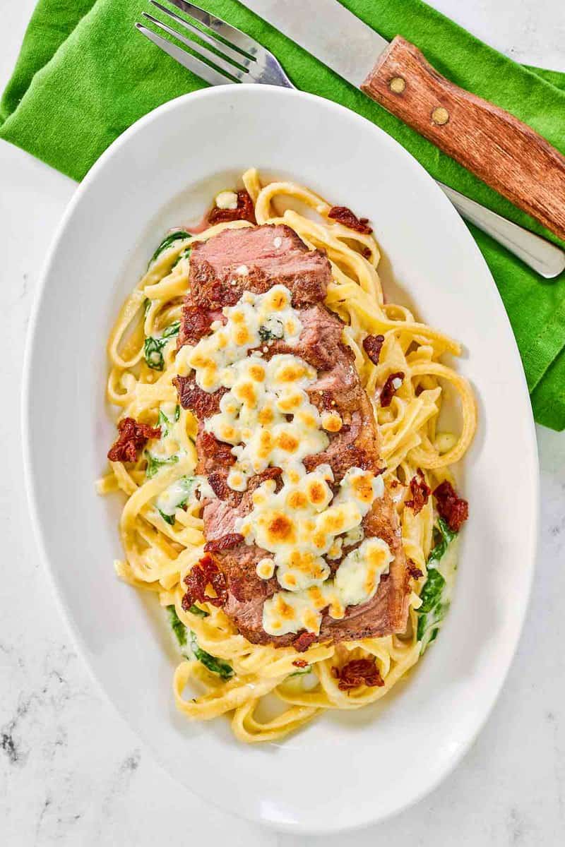 Copycat Olive Garden steak gorgonzola fettuccine alfredo on a platter.