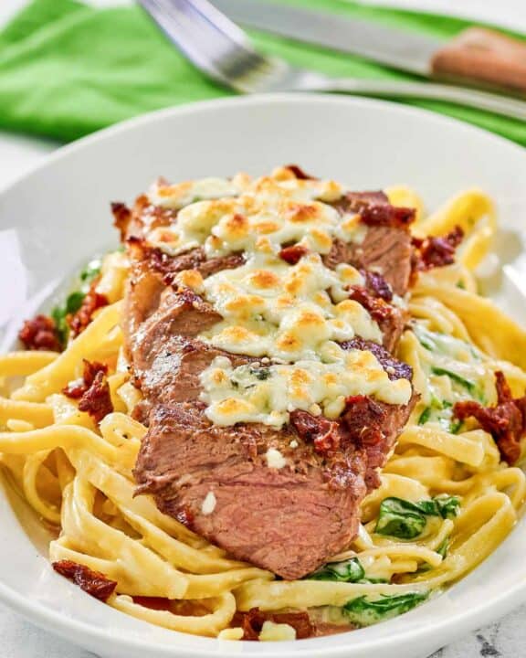 Copycat Olive Garden steak gorgonzola alfredo on a platter.