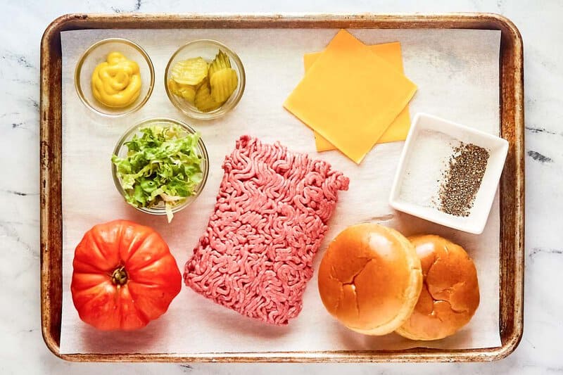 Copycat Chili's oldtimer burger with cheese ingredients on a tray.