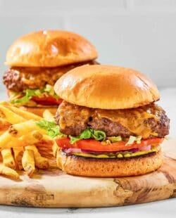 Two copycat Chili's oldtimer burgers with cheese and French fries.