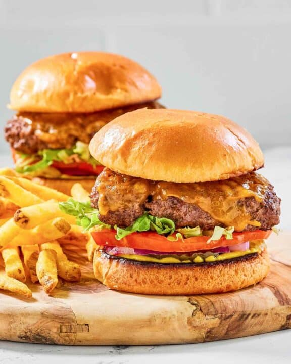 Two copycat Chili's oldtimer burgers with cheese and French fries.