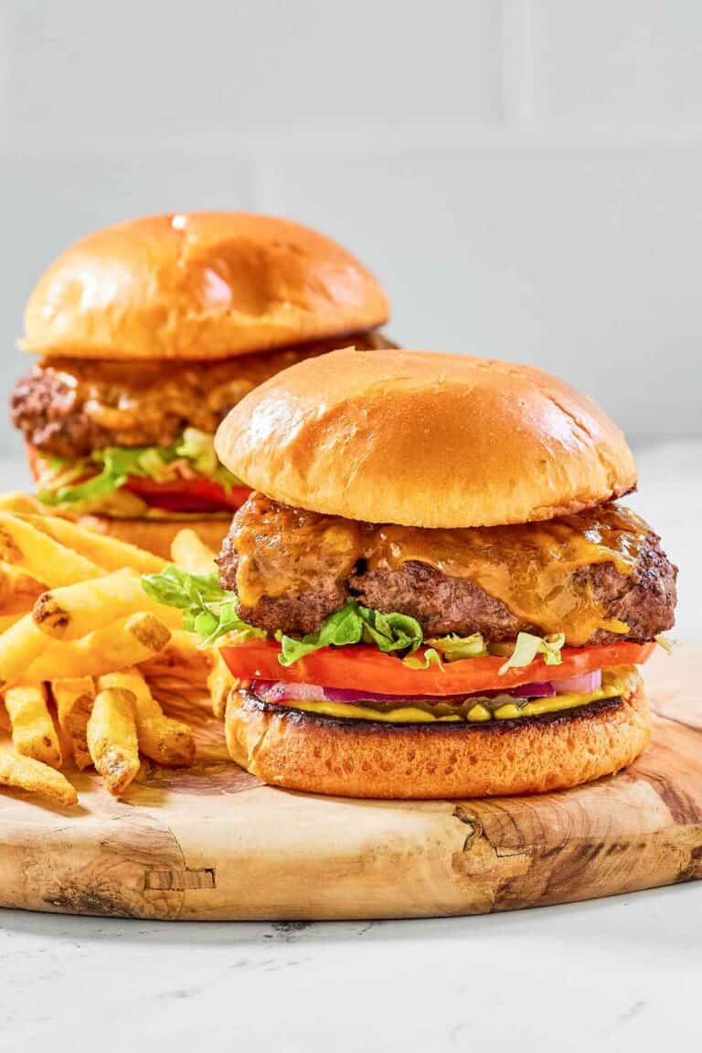 Two copycat Chili's oldtimer burgers with cheese and French fries.