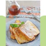 Copycat Denny's French toast on a plate and a bottle of syrup behind it.