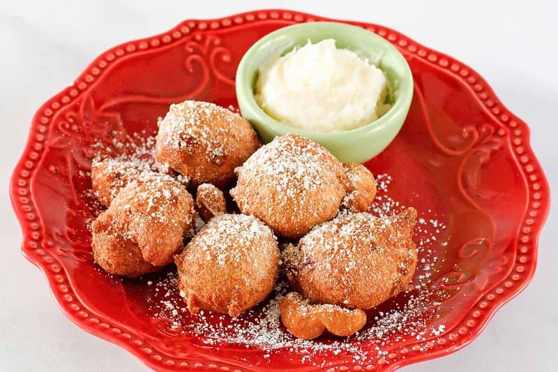 Copycat Denny's strawberry pancake puppies and cheesecake dip on a small plate.