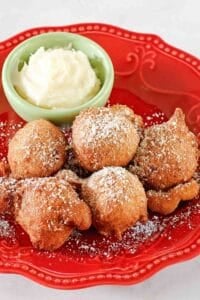 Copycat Denny's strawberry pancake puppies and a small bowl of cheesecake dip.
