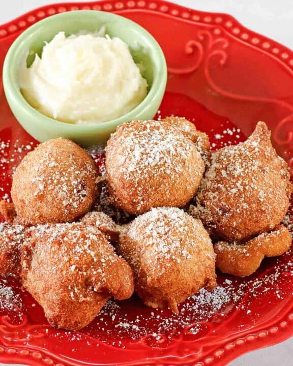 Copycat Denny's strawberry pancake puppies and a small bowl of cheesecake dip.