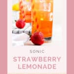 Two glasses of copycat Sonic strawberry lemonade and two strawberries.