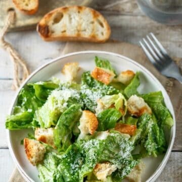 Copycat Anthony's Caesar salad and toasted bread slices.