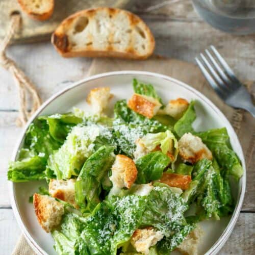 Copycat Anthony's Caesar salad and toasted bread slices.