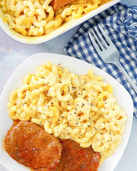 Copycat Boston Market mac and cheese in a baking dish and on a plate.