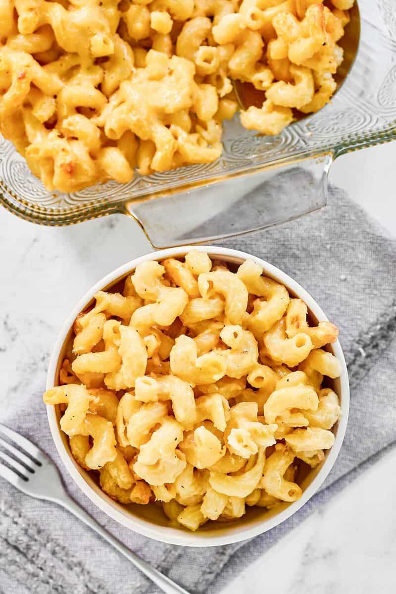 Copycat Costco mac and cheese in a baking dish and bowl.