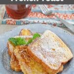 Homemade Denny's French toast on a plate, a fork, and bottle of syrup.