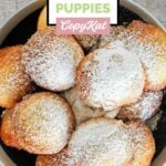 A bowl of homemade Denny's pancake puppies with powdered sugar in a bowl.