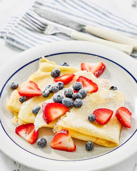 Copycat IHOP fresh berry crepes on a plate.