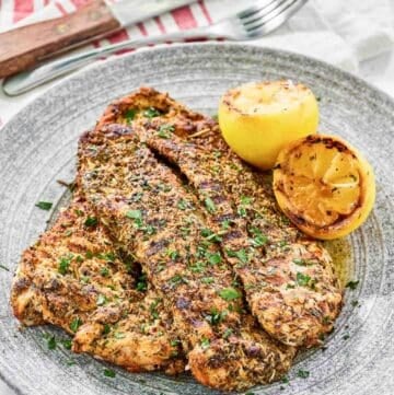 Copycat Texas Roadhouse herb crusted chicken on a plate.