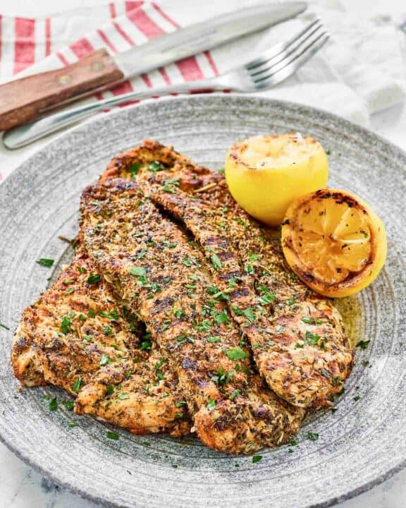 Copycat Texas Roadhouse herb crusted chicken on a plate.