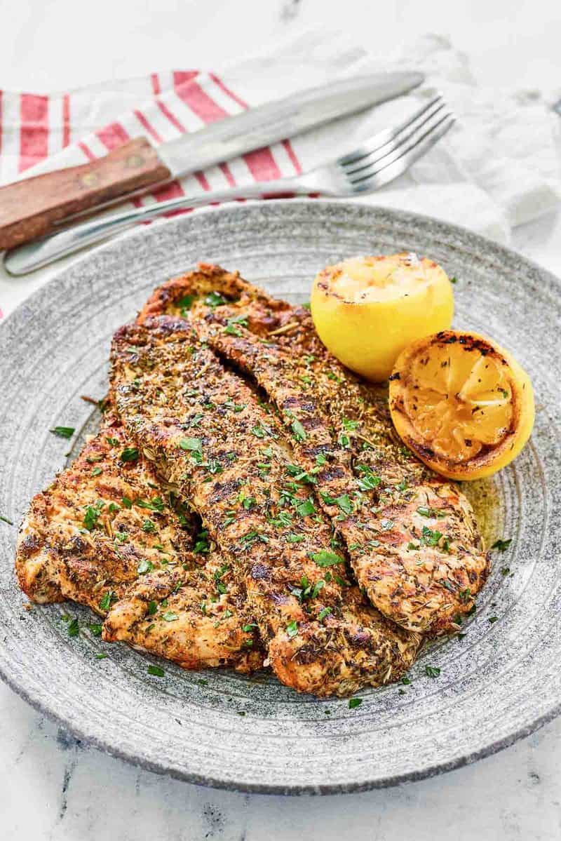 Copycat Texas Roadhouse herb crusted chicken on a plate.