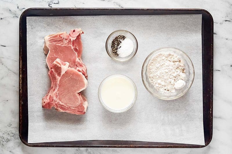 Copycat Cracker Barrel country fried pork chops ingredients on a tray.