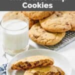 Homemade Crumbl chocolate chip cookies and a glass of milk next to them.