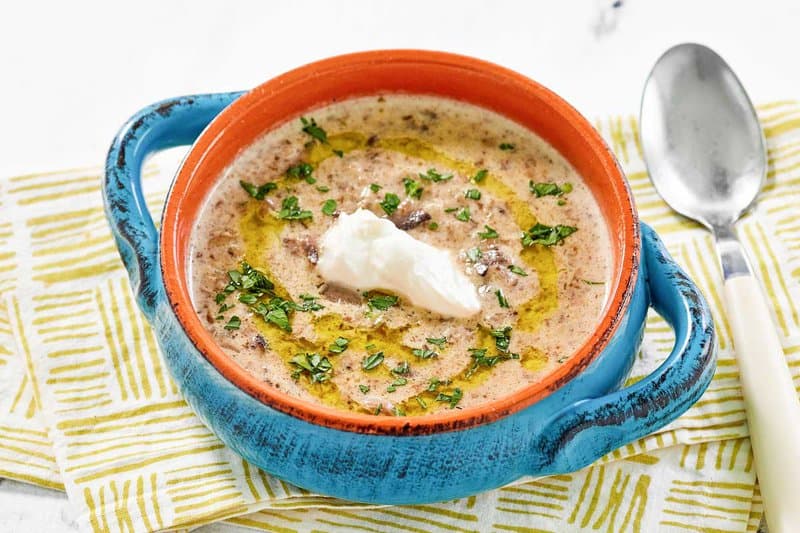 Copycat Longhorn Steakhouse mushroom bisque in a bowl and a spoon next to it.