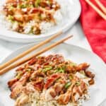 Copycat Panda Express grilled teriyaki chicken over rice on two plates.